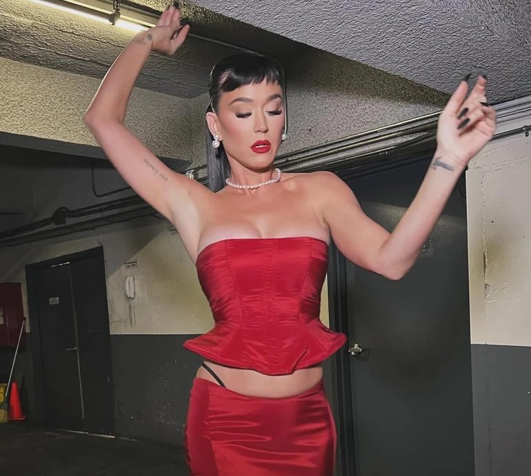 Кеті Перрі епатувала хідник метеликом на попереку та голою дупцею крізь шнурівку спідниці. Фото