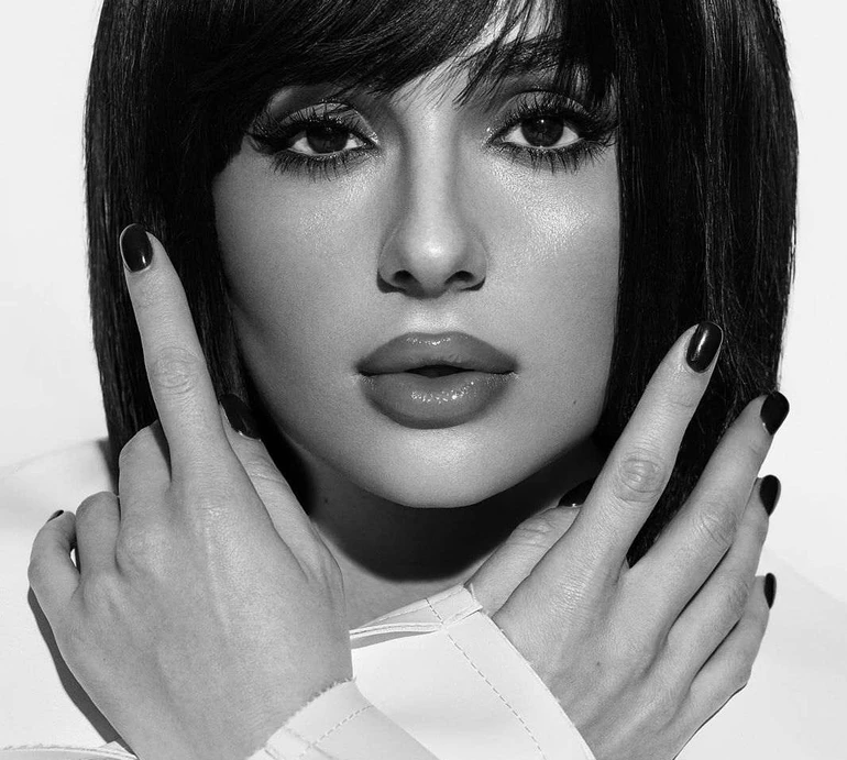 Трінчер із незвичною зачіскою та в провокаційних позах посвітила голими грудьми з-під тренча