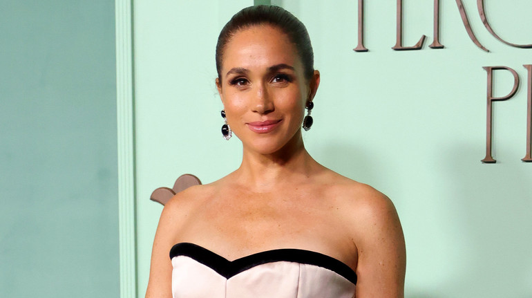 Меган Маркл у елегантній сукні кольору слонової кістки та довгому кардигані попозувала на хіднику студії Paramount