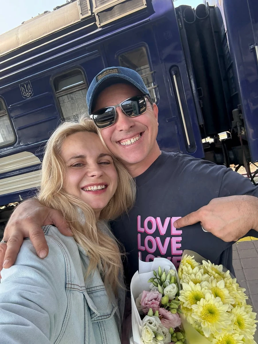 Лілія Ребрик з квітами попозувала біля чоловіка на вокзалі