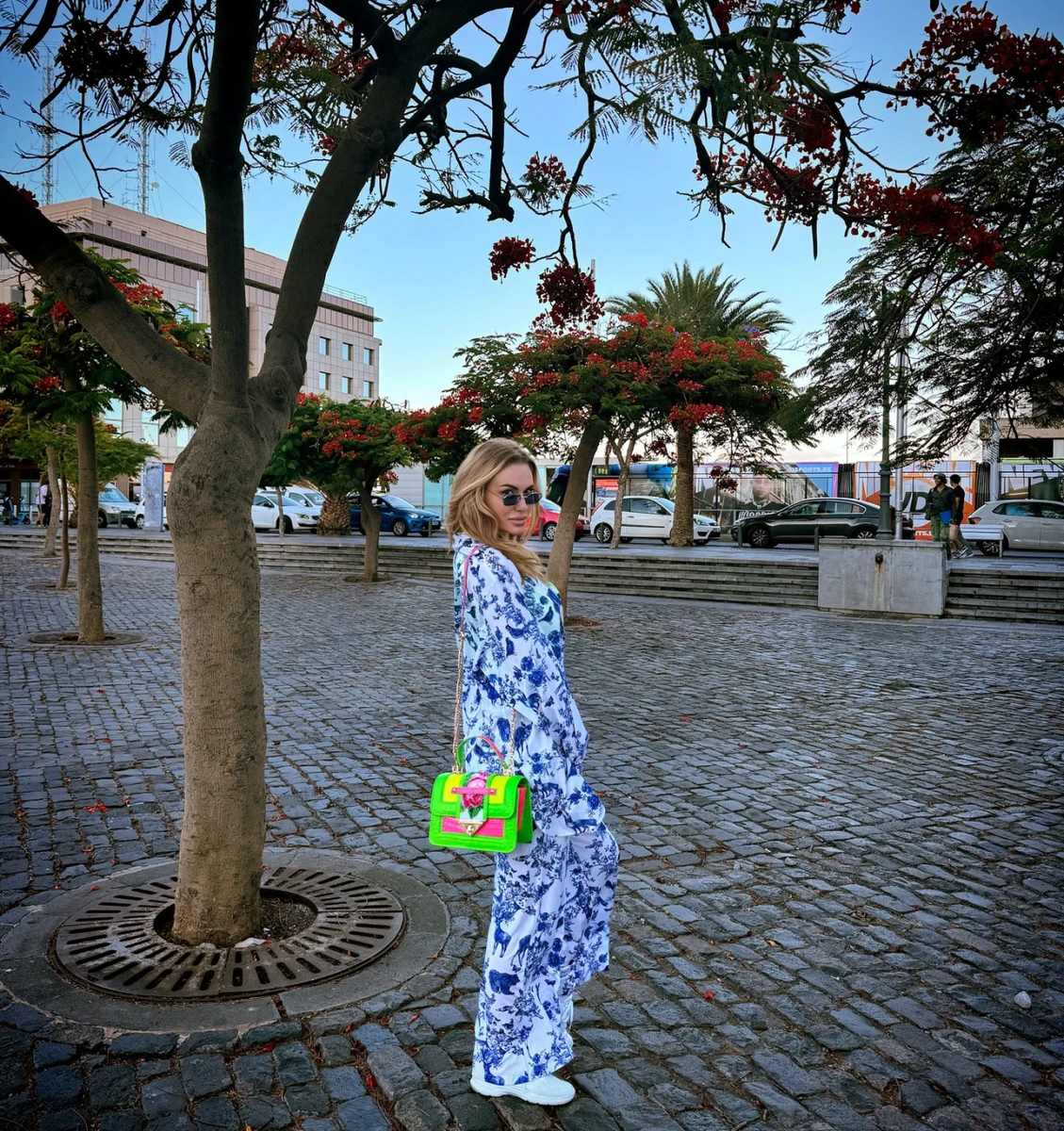 Слава в костюмі на тлі пальм